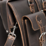 This is the front pocket of a dark brown leather briefcase upclose for lawyers.