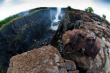 This is a dark brown full grain leather briefcase at Victoria Falls in Africa during dry season.