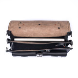 This dark brown leather briefcase is wide open with two gussets and a light tan interior.