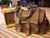 This is a full grain leather briefcase with a harmonica and amp next to it.