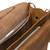 This is a close up of the tan brown leather briefcase open with a laptop inside.