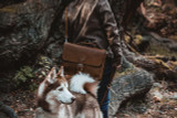 This is a picture that a customer took of their dark brown leather briefcase with their dog.