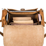 This is the inside of the tan leather backpack with a light beige tan interior.