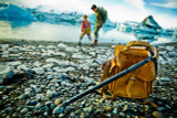 The back picture of the tan brown leather backpack in Iceland with two boys playing by the water.