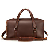 This is a red brown leather duffle bag that has three straps to close it and has two round handles from the back side.