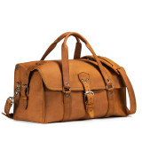 This is a tan brown leather duffle bag that has three straps to close it and has two round handles from the front side.