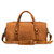 This is a tan brown leather duffle bag that has three straps to close it and has two round handles from the back.