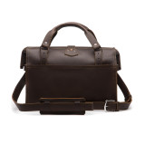 This is the back of a dark brown leather duffle bag with a gladstone bag closure.