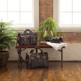 This is a dark brown overnight leather duffle bag with a leather briefcase above it.