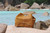 tan brown leather duffle bag using only one strap instead of three and using the built in handles instead of the detachable one.