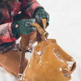This is a tan brown leather duffle bag with a man getting overnight travel gear out of it.