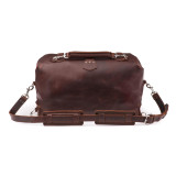 This is a red brown leather duffle bag with three straps on the front but not showing. This overnight bag has no straps on the back.