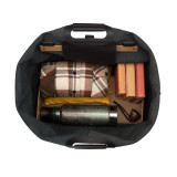 This is the interior of a black leather duffle bag that is wide open and the overnight travel gear can be seen inside.