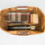 This is a tan brown leather duffle bag wide open to hold overnight travel gear.