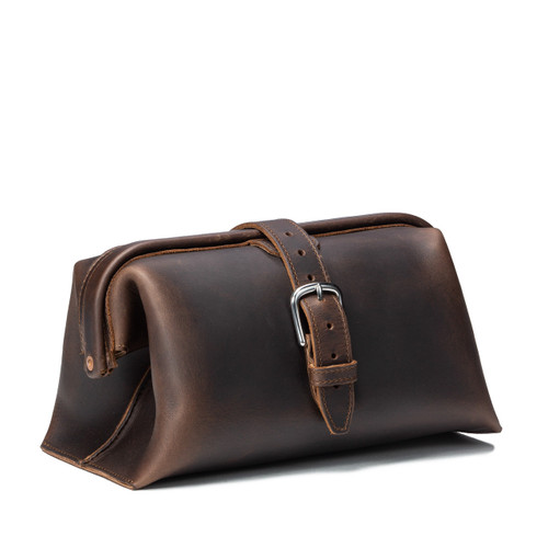 This is a dark brown leather toiletry bag on the front side.