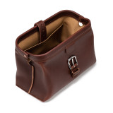 This is a red brown leather toiletry bag on the top side.