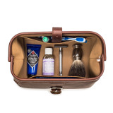This is a red brown leather toiletry bag on the opened and loaded.