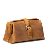 This is a tan brown leather toiletry bag on the front side.