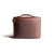 This is the back side of a red brown leather satchel with a front pocket.