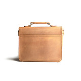 This is the back side of a tan brown leather satchel with a front pocket.