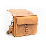 This is the front side of a tan brown leather satchel with a front pocket showing.