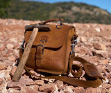 This is a tan leather satchel that is known as the Indiana Satchel. We would call it the Indiana Jones Satchel but we would get sued. It is the exact dimensions of his man bag.
