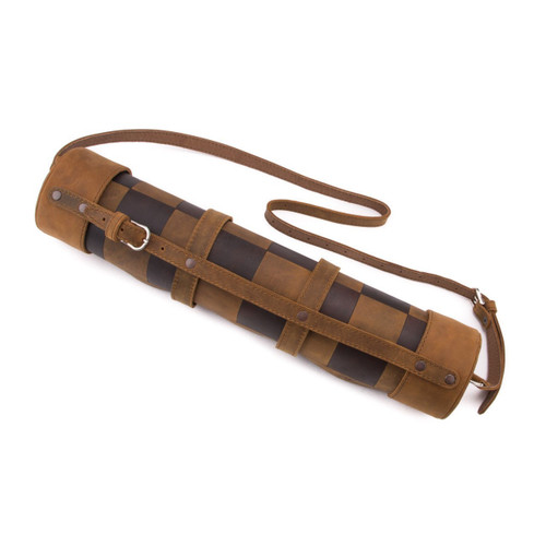 This is a leather travel chess set that is rolled up with a shoulder strap.