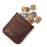 This is a red brown leather coin purse that has change spilling out of the pouch.