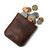 This is a dark brown leather coin purse that has change spilling out of the pouch.