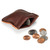 This is a red brown leather coin purse that has change spilling out in front of the pouch.