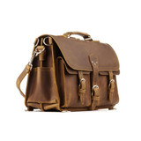 This is a brown leather briefcase that has front pockets and his big.
