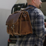 This is a leather briefcase used as a laptop backpack.