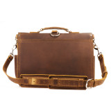 This is the back view of a brown leather briefcase with a shoulder strap.