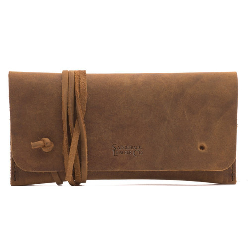 This is a tan brown leather wallet bag with a wrap around it to close it from the front.