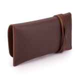 This is a red brown leather wallet bag with a wrap around it to close it from the back.