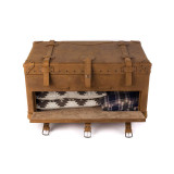 This is a leather trunk that will be a vintage antique one day in a museum. This is the front door of it that is open straight on. It is a tan brown steamer trunk that was old time luggage back in the day on trains and ships.