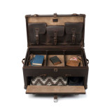 This is a leather trunk that will be a vintage antique one day in a museum. This is the luggage wide open and empty. It is a dark brown leather steamer trunk that was old time luggage back in the day on trains and ships.