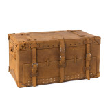 This is a leather trunk that will be a vintage antique one day in a museum. This is the front angled side. It is a tan brown steamer trunk that was old time luggage back in the day on trains and ships.