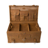 This is a leather trunk that will be a vintage antique one day in a museum. This is the luggage wide open and empty. It is a tan brown steamer trunk that was old time luggage back in the day on trains and ships.