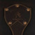 This is a leather trunk that will be a vintage antique one day in a museum. This is the family crest of the brand. It is a dark brown steamer trunk that was old time luggage back in the day on trains and ships.