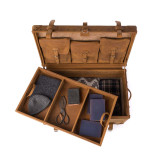 This is a leather trunk that will be a vintage antique one day in a museum. This is the back of the luggage when the tray is moved. It is a tan brown steamer trunk that was old time luggage back in the day on trains and ships.