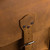 This is a leather trunk that will be a vintage antique one day in a museum. This is the strap and where it closes on it.. It is a tan brown steamer trunk that was old time luggage back in the day on trains and ships.