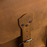 This is a leather trunk that will be a vintage antique one day in a museum. This is the strap and where it closes on it.. It is a tan brown steamer trunk that was old time luggage back in the day on trains and ships.