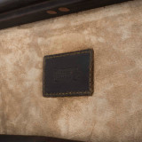 This is a leather trunk that will be a vintage antique one day in a museum. This is the leather tag on the inside. It is a dark brown steamer trunk that was old time luggage back in the day on trains and ships.
