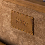 This is a leather trunk that will be a vintage antique one day in a museum. This is the leather tag on the inside. It is a tan brown steamer trunk that was old time luggage back in the day on trains and ships.