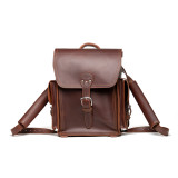 This is a red brown leather backpack from the front of the bag showing the shoulder strap.