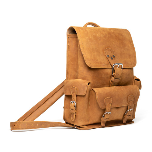 This is an image of a tan brown leather backpack on the front side. It is a three pocket backpack made of full grain leather for men and women.