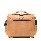 This is the back view  of a tan brown rounded leather satchel.