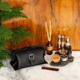 This is a black leather toiletry bag in a bathroom.