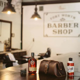 This is a dark brown leather toiletry bag at the barber shop.
